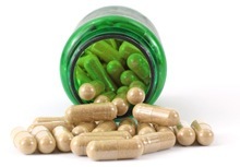 open-green-bottle-filled-with-capsules