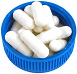 white-capsules-in-lid-of-pill-bottle